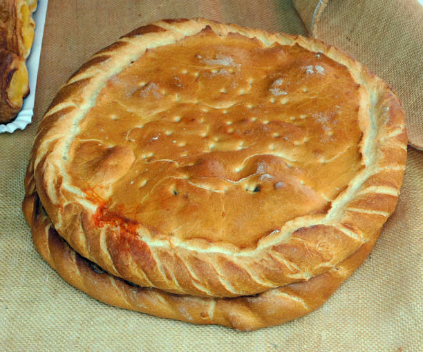istock A large, round empanada with golden-brown, flaky crust 2205425966