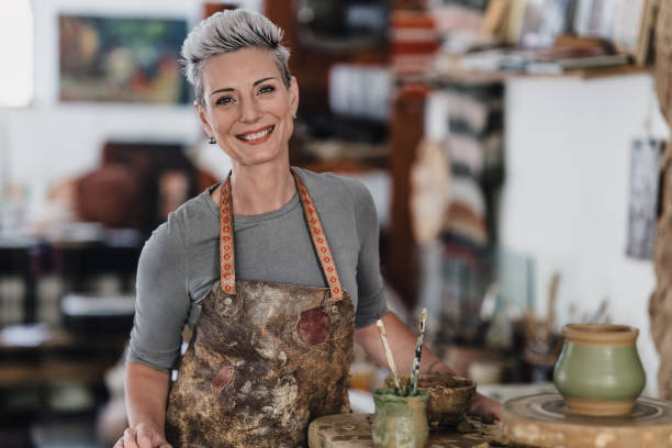 istock Smiling female potter artist 2205428300