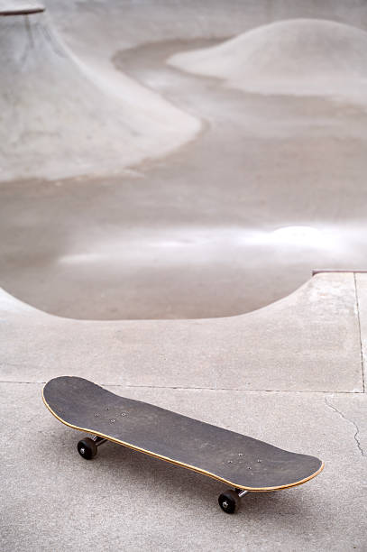 A skateboard or a longboard on a pump trek or a pump ramp, copy space. High quality photo