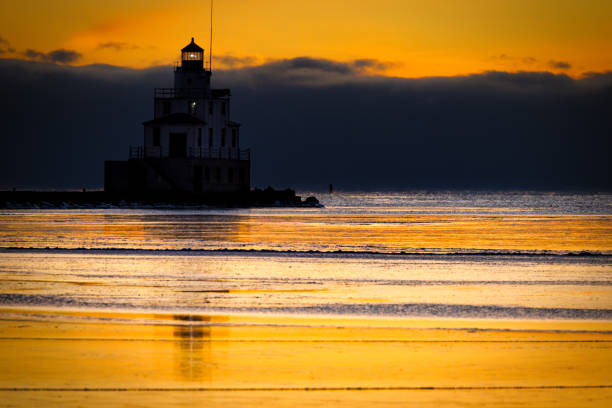 Orange skies at the frozen harbor and lighthouse in Manitowoc, Wisconsin.