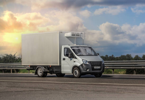 istock truck with a container moves along a country highway 2205431416