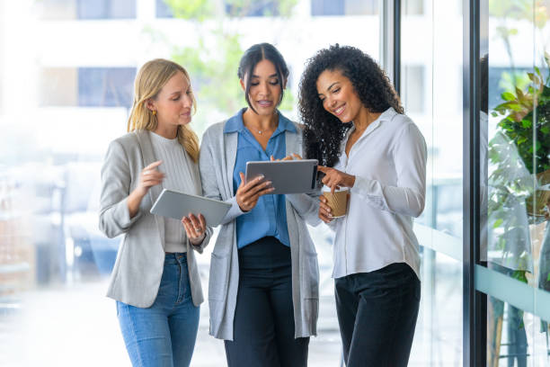istock Three business women working looking at digital tablets. 2205432947