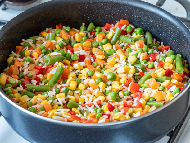 istock rice and vegetables mix in a pan 2205433624