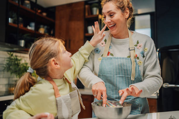 istock Mother and daughter having fun while baking in the kitchen 2205435952