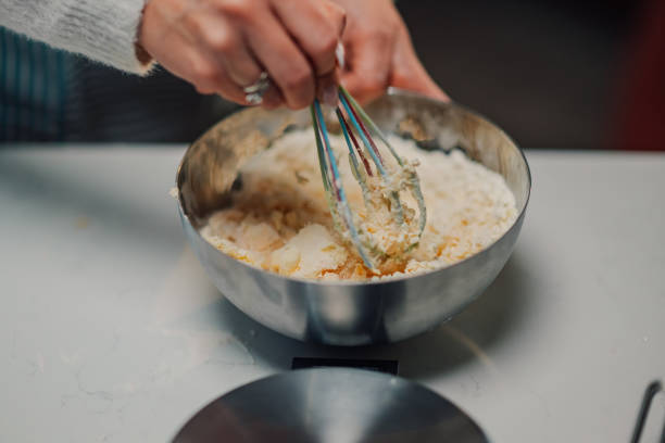 istock Woman whisking ingredients in a bowl for baking 2205435960