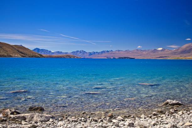 istock Serene Lake with Turquoise Waters and Mountains 2205437375