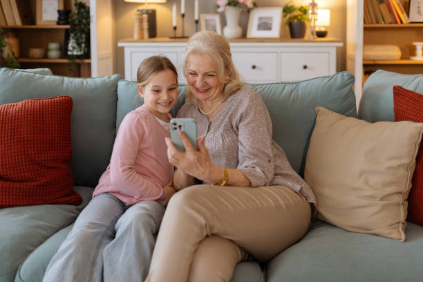 istock Grandmother and Grandchild Smiling While Exploring a Smartphone Together 2205438275