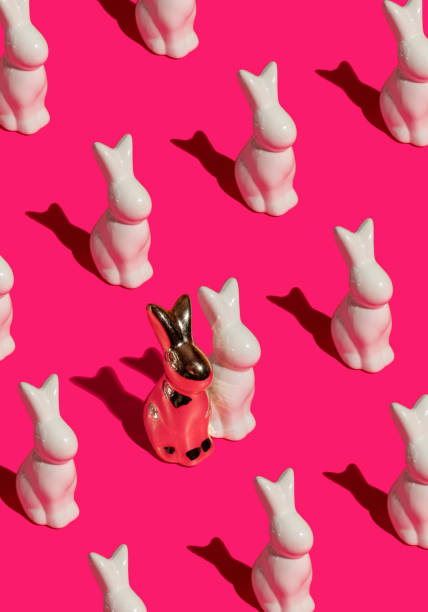 istock Pattern composition of Easter bunnies on hot pink background. Minimalist isometric concept. 2205439618
