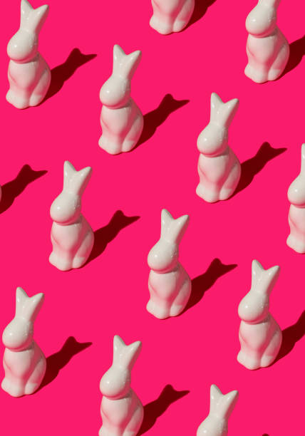 istock Pattern composition of Easter bunnies on hot pink background. Minimalist isometric concept. 2205439630