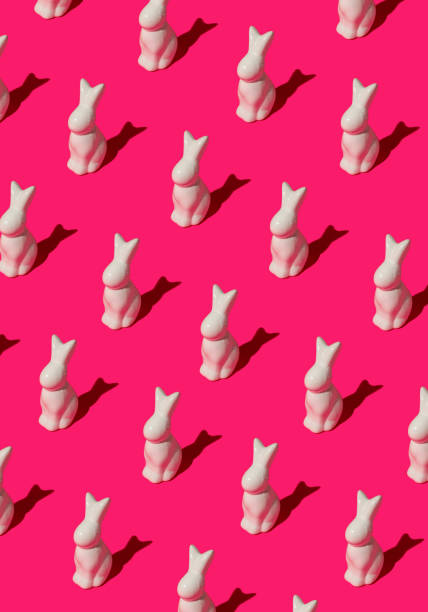 istock Pattern composition of Easter bunnies on hot pink background. Minimalist isometric concept. 2205439635
