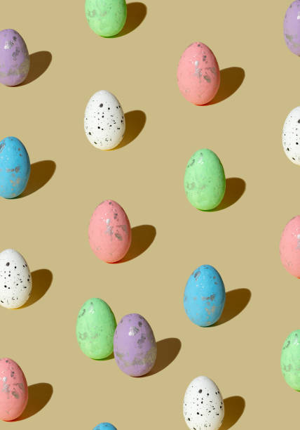 istock Pattern made of colored eggs on pastel beige background. Minimal Easter concept. 2205439651