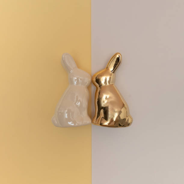 istock White and golden rabbits on a light background. Happy Easter concept. Close-up. 2205439664