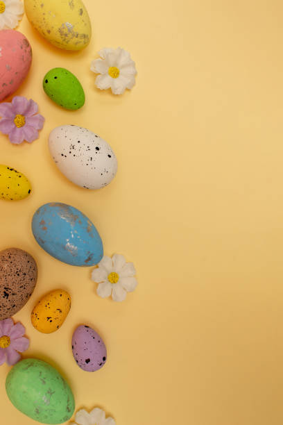 istock Easter composition made with colorful eggs on beige background. Creative minimal holiday concept. 2205439719