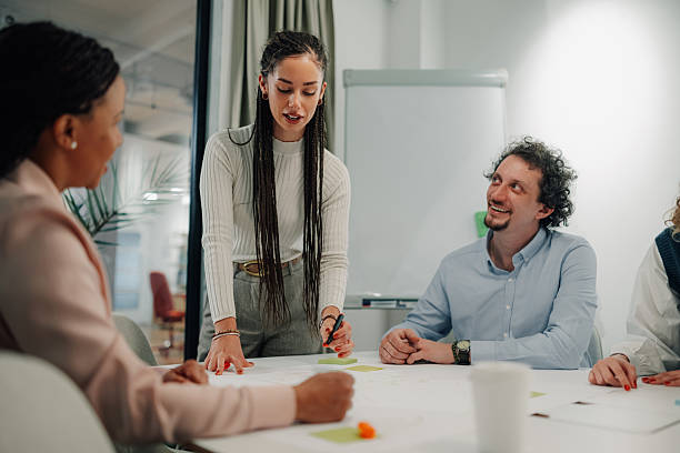 istock Young manager leading a business meeting with her team 2205441228