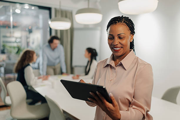 istock Smiling businesswoman using digital tablet during office meeting 2205441238
