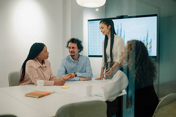 istock Business team analyzing charts on a digital screen during a meeting 2205441276