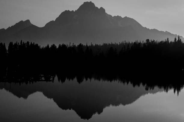 istock The Teton mountain range reflection on a calm lake 2205443771