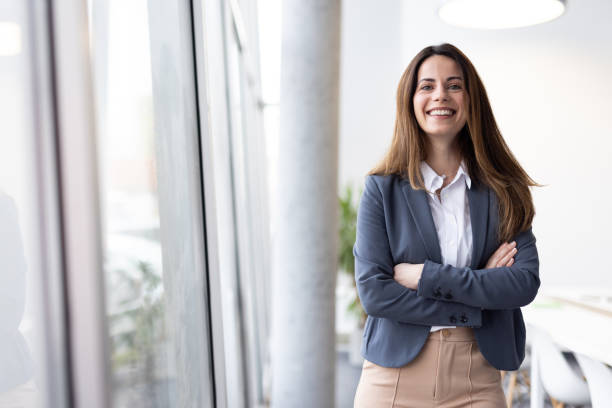 istock Smiling Businesswoman Posing Confidently in Office Space 2205446739
