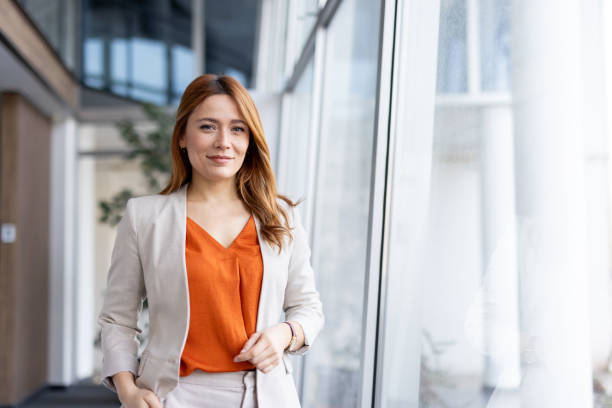 Confident woman poses in a modern office with natural light