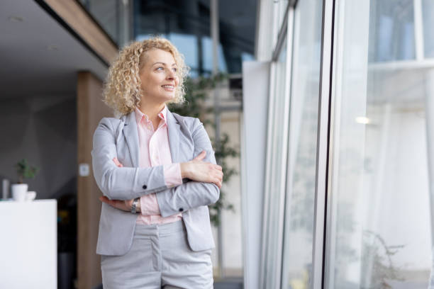 istock Confident Businesswoman in Modern Office Setting Smiling 2205446766
