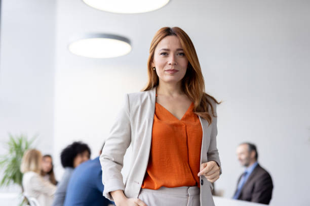 istock Cheerful businesswoman giving standing in office setting. 2205446773
