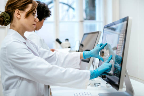 istock Young Caucasian Female Researcher Analyzing Data in a University Lab 2205446816