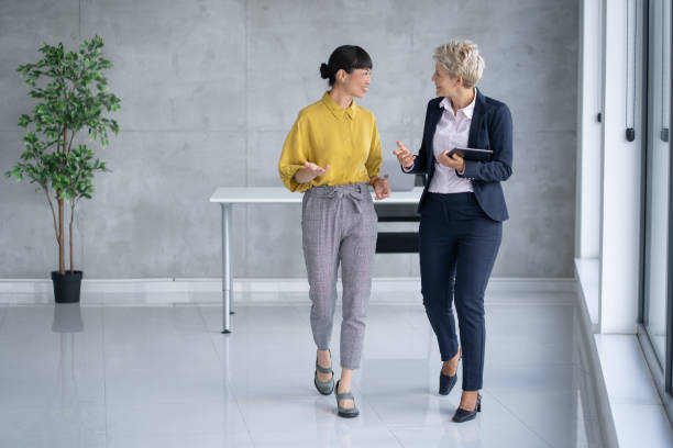 istock Two Women Engaging in Professional Conversation in Office 2205446909