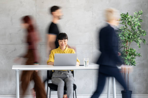 istock Focused Female Worker with Laptop in Modern Office Space 2205446916
