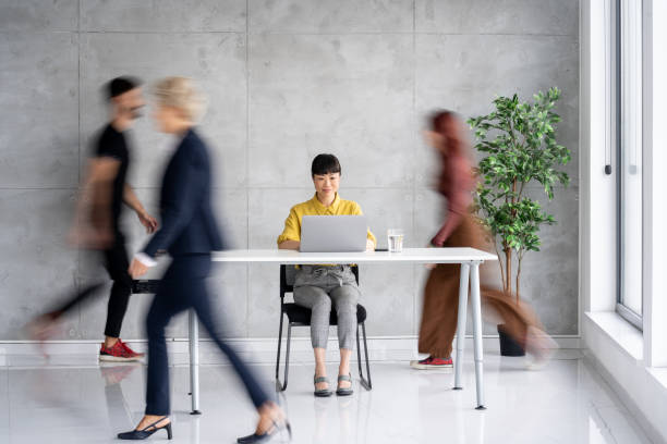 istock Focused Woman Working in a Fast-Paced Office 2205446920