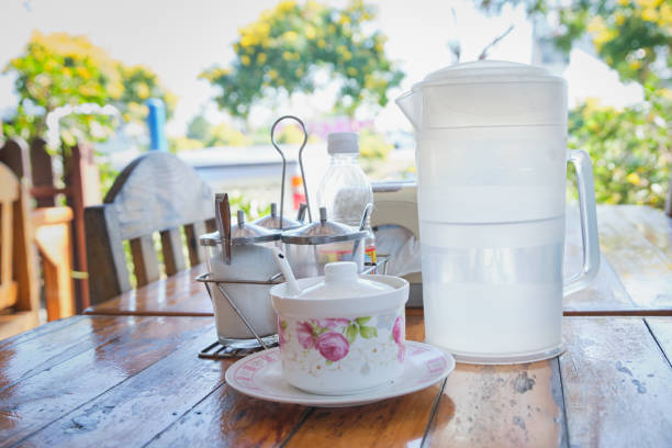 Water drink in clear plastic jug on wood table