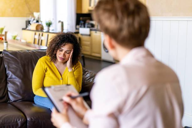 istock Female client is talking to an unrecognizable conselor 2205453716