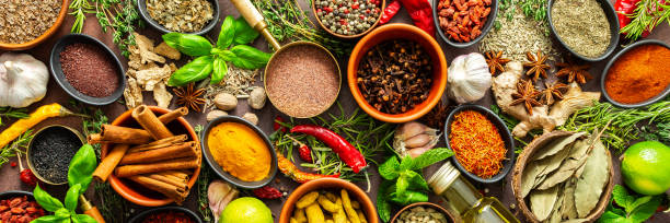 istock A visually striking arrangement of fresh spices and herbs on a brown surface, highlighting their vivid colors, intricate details, and rich culinary essence, banner 2205455058