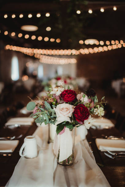 istock Flower arrangement at wedding reception with sting lights 2205456277
