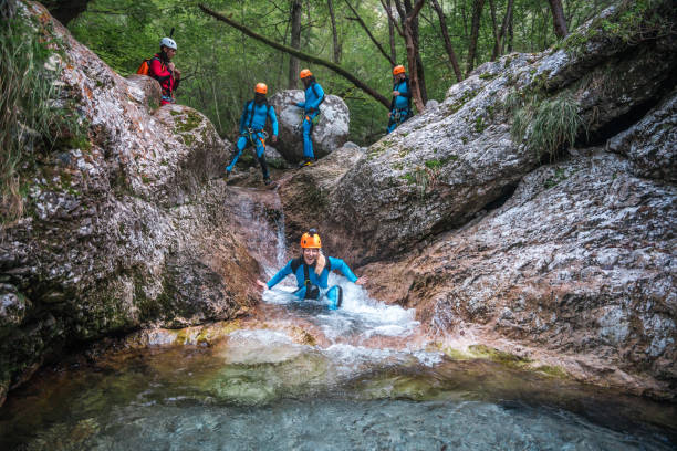 istock Diverse Friends Canyoning in Neoprene Suits and Helmets 2205456436
