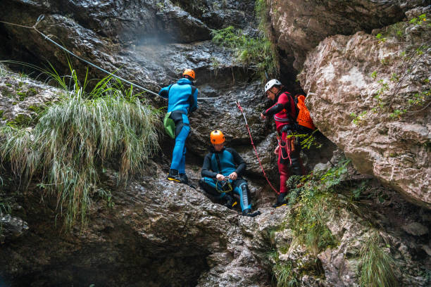 istock Diverse Friends Climbing Together with Canyoning Guide 2205456453