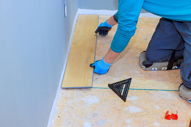 istock Installer laying wooden flooring with precision tools in a home renovation project 2205458144