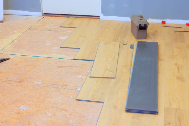 istock Floor renovation in progress with laminate planks laid out and tools ready for installation 2205458152
