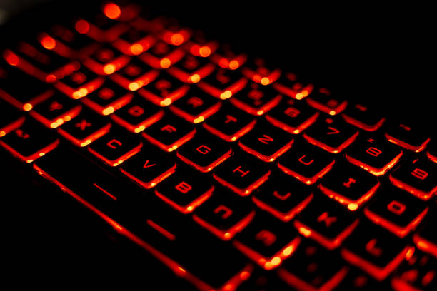 istock Close-Up of a Red Backlit Gaming Laptop Keyboard 2205459552