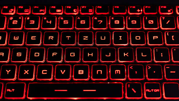 istock Close-Up of a Red Backlit Gaming Laptop Keyboard 2205459555