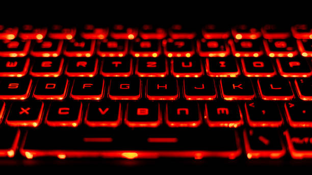 istock Illuminated Red Gaming Laptop Keyboard Close-Up 2205459559