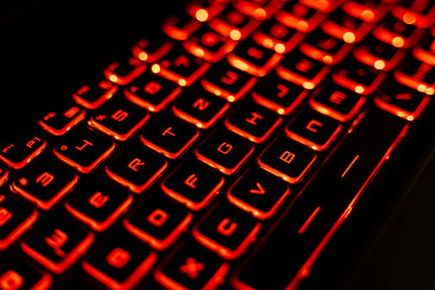istock Close-up of a Red Backlit Gaming Laptop Keyboard 2205459560