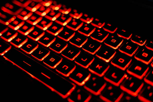 istock Close-Up of a Red Backlit Gaming Laptop Keyboard 2205459565