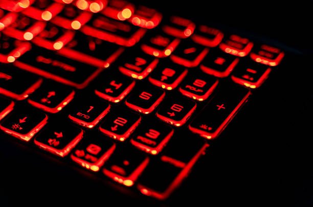 istock Close-Up of a Red Backlit Gaming Laptop Keyboard 2205459567