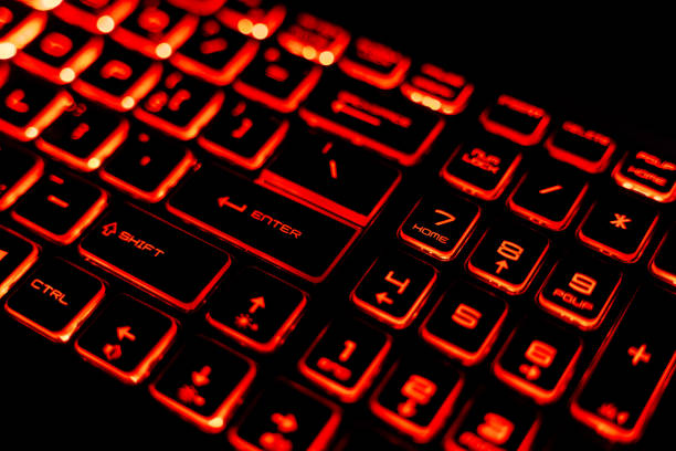 istock Close-Up of a Red Backlit Gaming Laptop Keyboard 2205459568