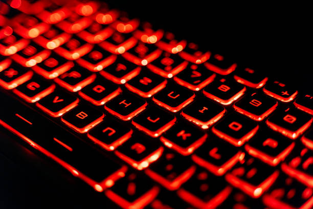 istock Close-Up of a Red Backlit Gaming Laptop Keyboard 2205459569