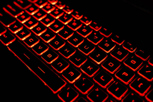 istock Close-Up of a Red Backlit Gaming Laptop Keyboard 2205459575
