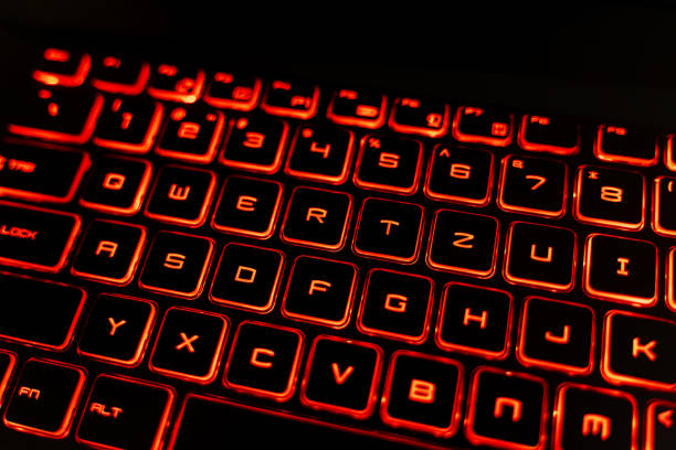 istock Close-up of a Red Backlit Gaming Laptop Keyboard 2205459578