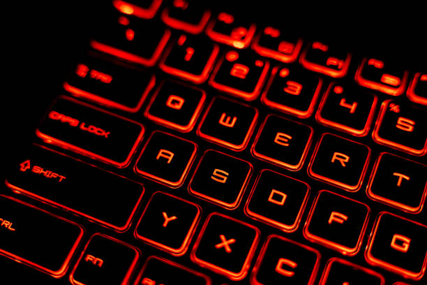 istock Close-Up of a Red Backlit Gaming Laptop Keyboard 2205459580