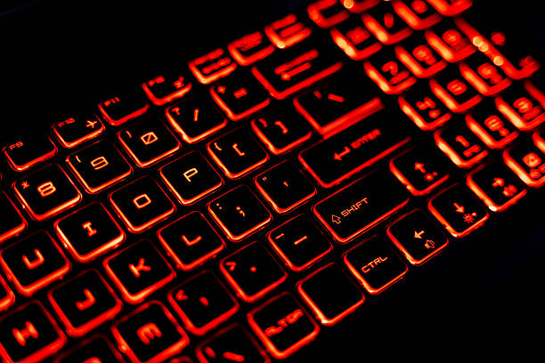 istock Close-Up of a Red Backlit Gaming Laptop Keyboard 2205459581