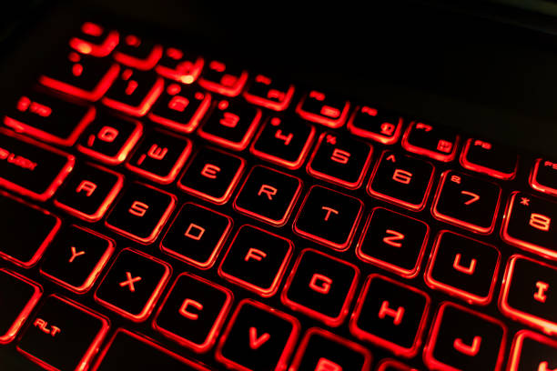 istock Close-up of a Red Backlit Gaming Laptop Keyboard 2205459582